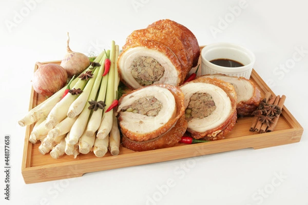 Fototapeta bbq roasted pork meat roll stuffed with special ingredients serve with chef sauce in white background Christmas festival menu