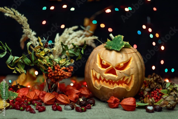 Fototapeta Halloween Still life with Jack-o-Lantern pumpkin and autumn leaves. Focus on the foreground. Autumn festive still life. 
