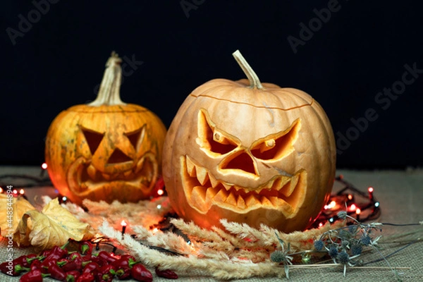 Fototapeta Halloween Still life with Jack-o-Lantern pumpkin and autumn leaves. Focus on the foreground. Autumn festive still life. 
