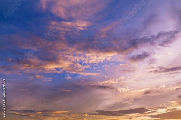 Fototapeta Sunset skyline with fluffy clouds in bright colors. Beautiful natural view of free space. Lovely sundown background.
