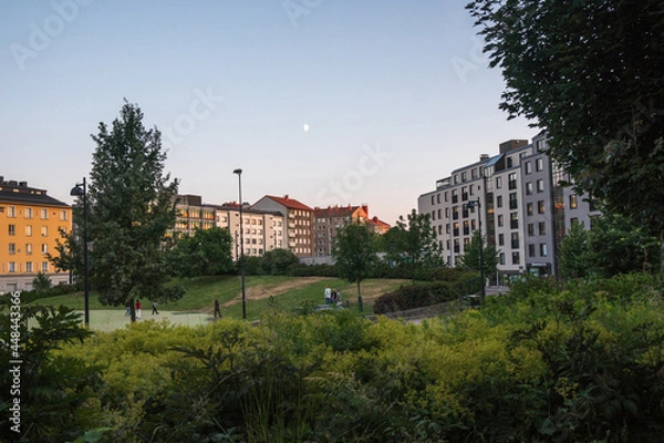 Fototapeta Helsinki, Finland - July 18th 2021: scandinavian buildings and a park in Helsinki duing warm season