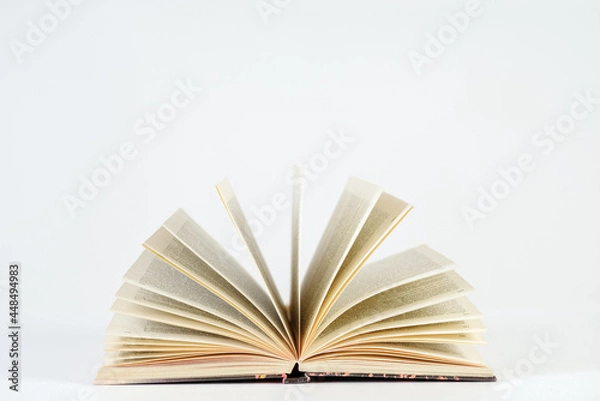 Fototapeta Opened book on a white background. Learning concept