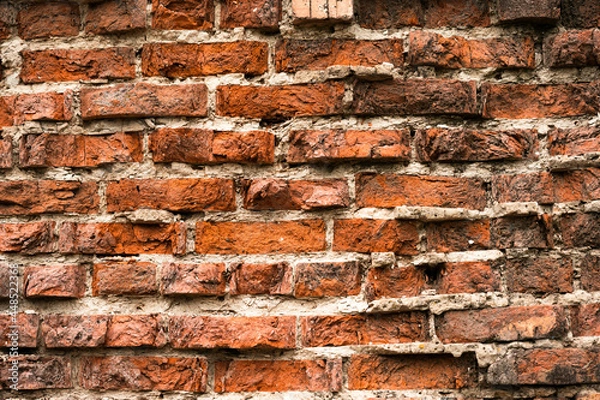 Fototapeta old crumbling red brick wall