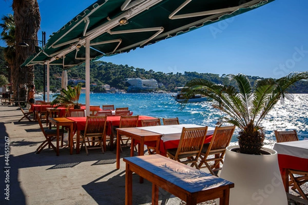 Fototapeta Lopud island in Croatia. Embankment and architecture of the island. View from the street cafe