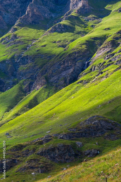 Obraz Mountain in the middle of the alps. Summer in the green mountain. Alpine mountains with a play of light and shadow of the clouds.