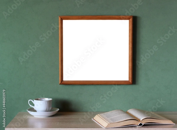Fototapeta mockup with a large empty frame on a green wall.
