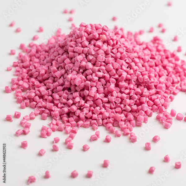 Fototapeta Pink granules of polypropylene or polyamide on a white background. Plastics and polymers industry. Copy space.