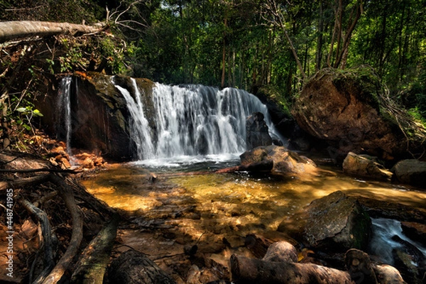 Fototapeta a large waterfall in a forest with sunlight