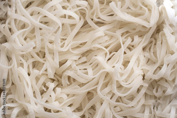 Obraz The texture of rice noodles. White noodles are visible throughout the frame. An ingredient for making a wok. Asian food. Asian pasta. Cooking food. Strid food. Gluten-free fries. Rice noodles.