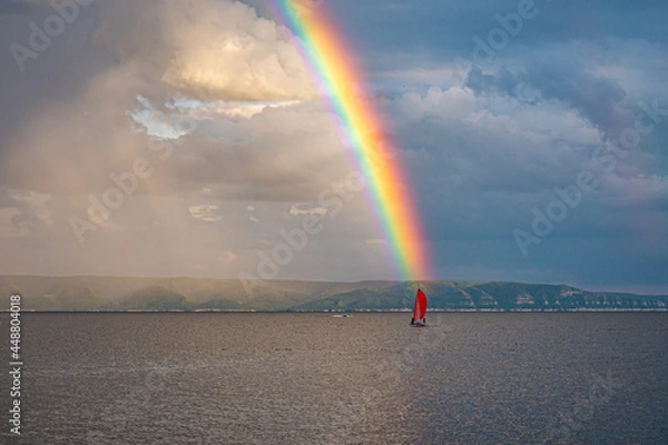 Obraz A bright rainbow over the river with a scarlet sail on the horizon