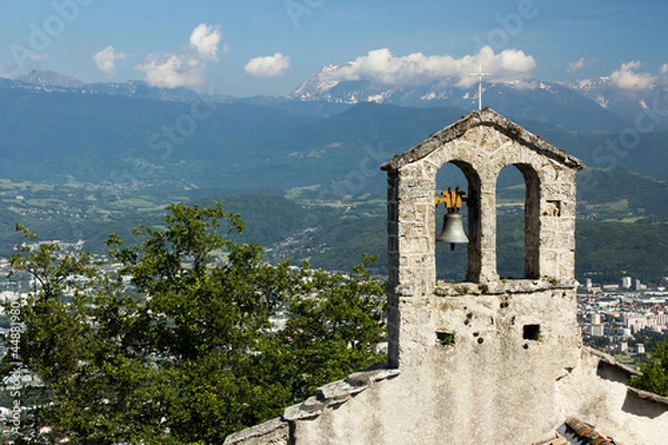 Fototapeta Church tower with bell. View on the alps