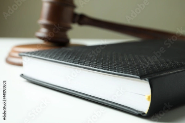 Fototapeta Judge gavel and law book on white table