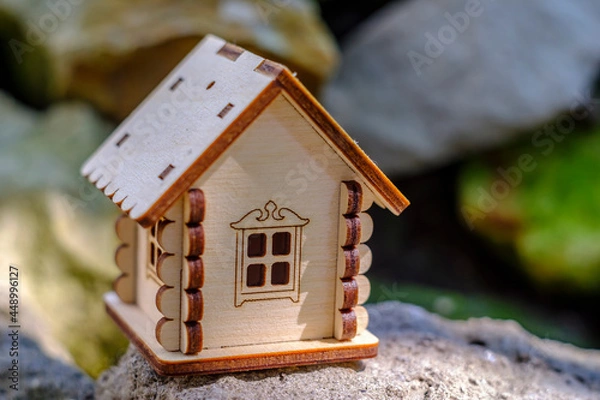 Fototapeta toy house on stone with greenery background