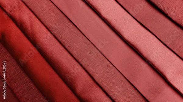 Fototapeta close up multi red tone of silk fabric samples in catalog. interior drapery or upholstery material palette background for interior concept. vintage drapery background.