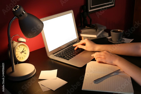 Obraz Woman working with laptop in office at night