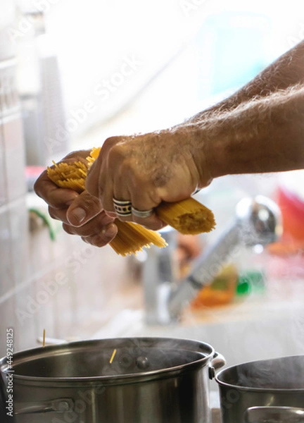 Obraz cooking pasta for dinner, working man hands
