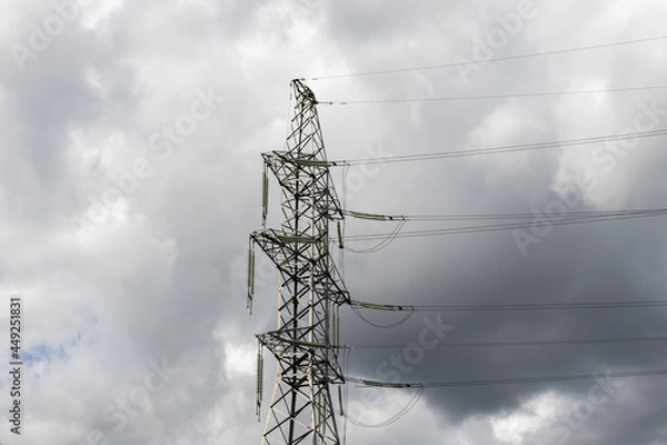 Fototapeta power lines close-up on the background of a black cloud