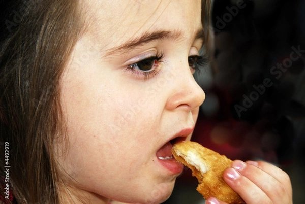 Fototapeta Enjoying Her Chicken Nugget