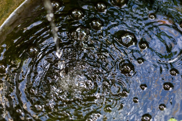 Fototapeta Air bubbles on the water surface in the fish pond from filling with clean water. Rinse the water in the fish pond after cleaning and add new water. Ideas for maintaining and cleaning fish pond