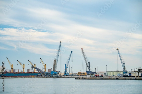 Fototapeta Port of Malaga with cranes and hoists for stevedores and logistics workers