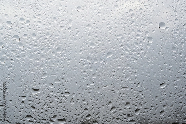 Obraz Rain drops on a window with blurred background. Selective focus.