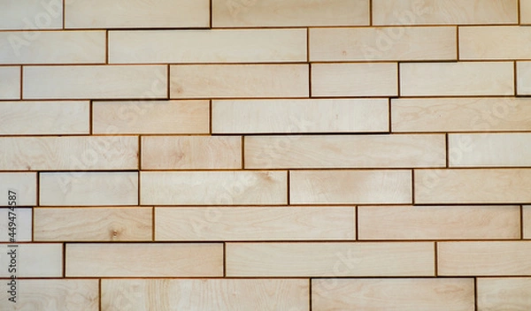 Fototapeta Background is made of wooden bricks. Decorative wall made of plywood parts. Pattern.