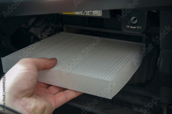 Fototapeta the process of installing the cabin filter. air purifier installed in the glove compartment