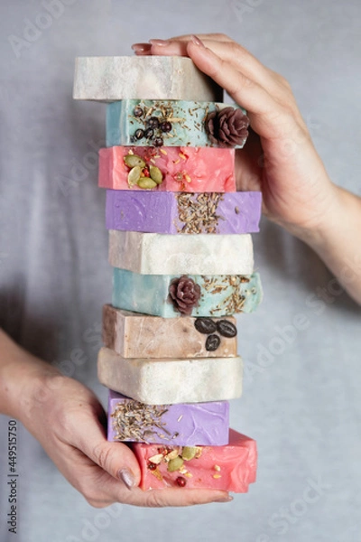 Fototapeta Female hands hold stack of handmade soap.