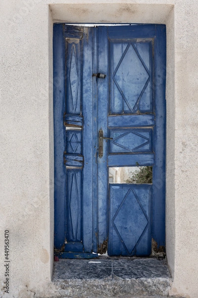 Fototapeta old broken blue door with white walls in Pyrgos, Santorini Greece