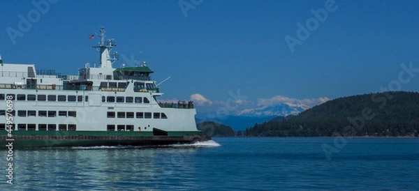 Fototapeta Washington State Ferry underway in the San Juan Islands with Mount Baker in the background.