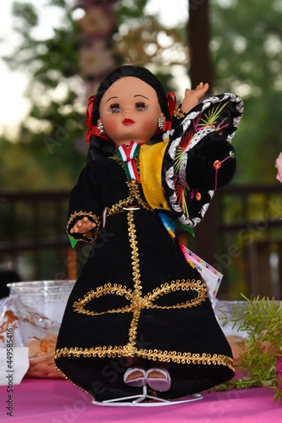 Fototapeta Doll dressed up as a mexican mariachi on top of a table.