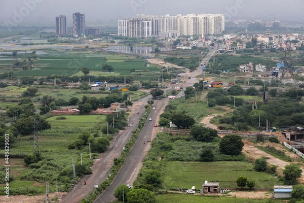 Fototapeta aerial landscape view of a developing city, outskirts of Delhi and Gurugram. Aerial View of Fields and towers.