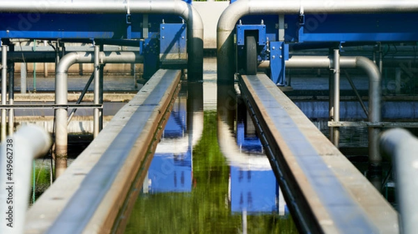 Fototapeta Detail from Wastewater treatment plant (Kläranlage) in germany, blue steel construction with pipes and rails. Filters dirty water from water bodies.