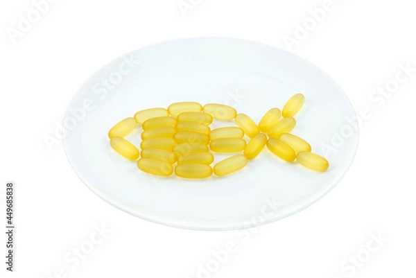 Fototapeta Fish oil capsules in the form of fish on a white plate. Isolated object. Omega 3, Vitamin D. Healthcare Concept. Healthy lifestyle