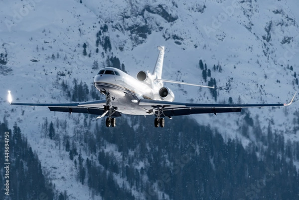 Fototapeta Luxury private jet approaching the engadin valley in the Swiss alps