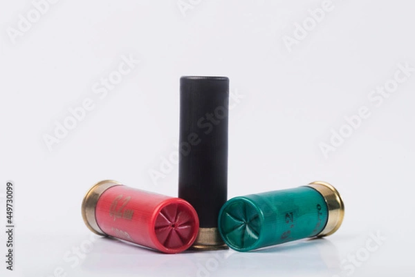 Fototapeta Hunting rifle cartridges. Cartridges on a white isolated background. Cartridges on a wooden table. 