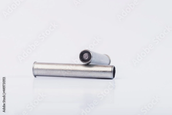 Fototapeta Hunting rifle cartridges. Cartridges on a white isolated background. Cartridges on a wooden table. 