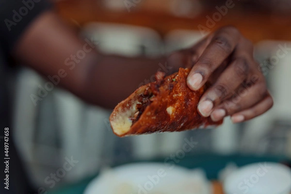 Fototapeta Close up of a hand holding a taco