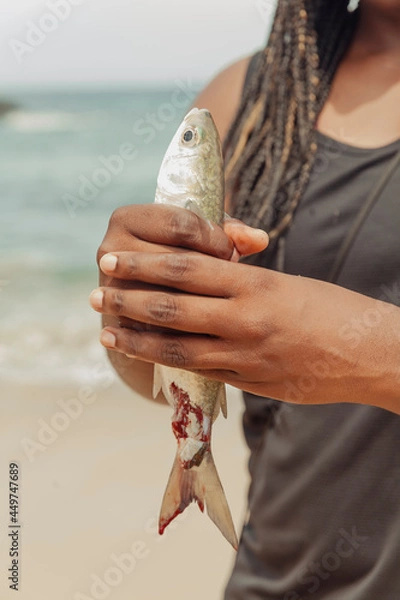 Fototapeta Freshly caught fish from the ocean being held in a person's hands