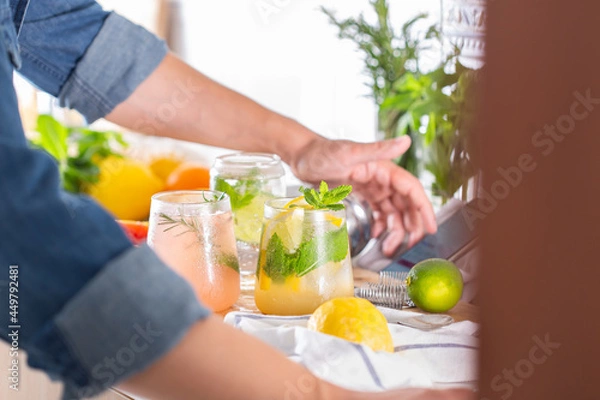 Fototapeta Mixologist making refreshing cocktails with hard seltzer at home