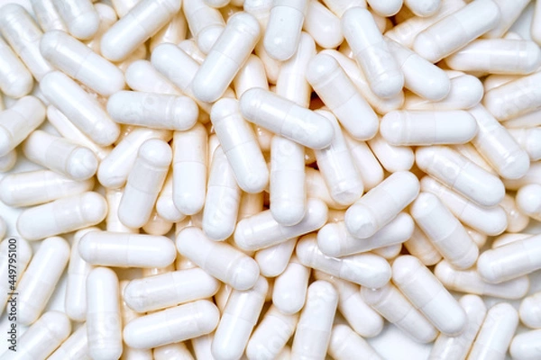 Obraz marine magnesium capsules on white background with advertising copy space. top view
