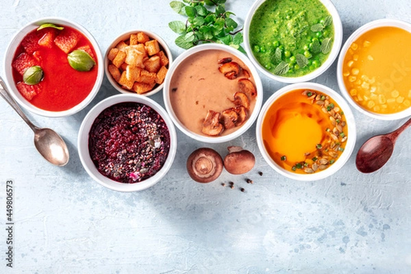 Fototapeta Vegan soup variety, fresh summer detox menu, top shot with a place for text. Colorful vegetable cream purees