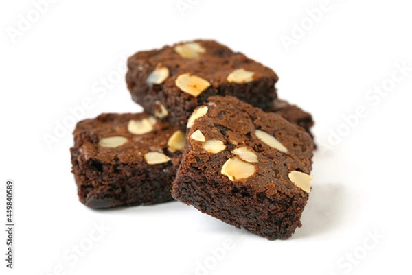 Obraz pieces of fresh homemade chocolate brownie, square shape, with sliced almond on top isolated on white background