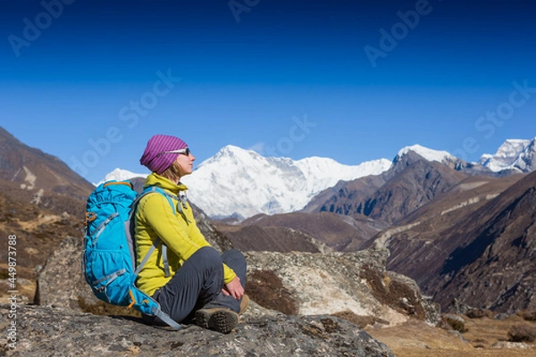 Fototapeta Woman Traveler with Backpack hiking in Mountains with beautiful summer Himalayas landscape on background
