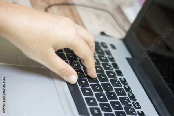 Fototapeta Top view, woman's hands typing work, on tablet keyboard at home close-up, blurred background