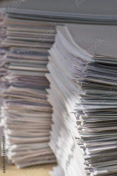 Fototapeta bundles bales of paper documents. stacks packs pile on the desk in the office. waste paper, paper trash