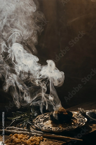 Obraz Charcoal burning with incense, incense resin, rosemary, laurel, lavender on a rustic wooden table, 
smudge stick, smudging, energetic cleansing and smoking.Sahumar
