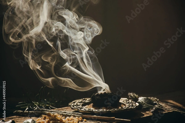 Obraz Charcoal burning with incense, incense resin, rosemary, laurel, lavender on a rustic wooden table, 
smudge stick, smudging, energetic cleansing and smoking.Sahumar
