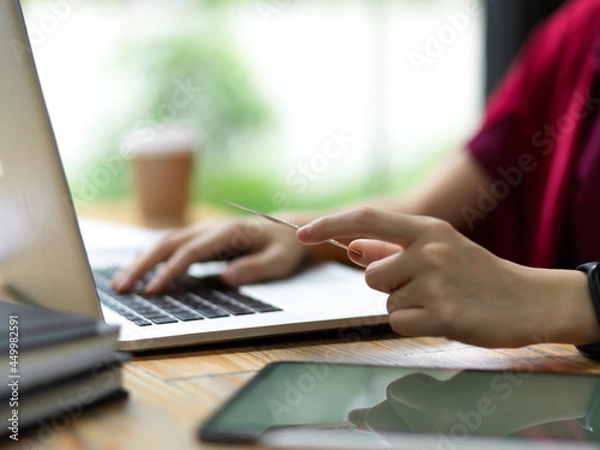 Fototapeta Auditor typing on laptop, working online via portable laptop