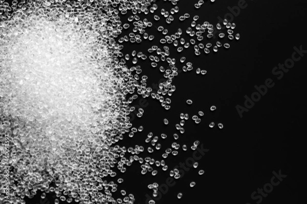 Fototapeta white granules of rubber and polypropylene on a black background. Plastics and polymers industry. Copy space